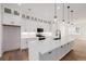 Modern kitchen boasts white cabinetry, stainless appliances, and a large island perfect for entertaining at 2361 Junegrass Ln, Superior, CO 80027