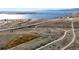 Scenic aerial view of a lakeside recreational area with walking paths and a bridge at 6898 W Rockland Pl, Littleton, CO 80128