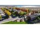 Aerial view of houses surrounded by fall foliage and a playground, in a residential neighborhood at 6898 W Rockland Pl, Littleton, CO 80128