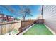 Cozy fenced backyard featuring artificial turf and stone edging offers easy maintenance at 6898 W Rockland Pl, Littleton, CO 80128
