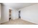 Bright bedroom with neutral carpet, white walls, and large closet space perfect for relaxing at 6898 W Rockland Pl, Littleton, CO 80128