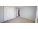 Carpeted bedroom with a closet and a light blue accent wall at 6898 W Rockland Pl, Littleton, CO 80128