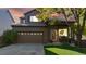 Charming two-story home featuring a well-maintained lawn, brick accents, and an attached two-car garage at 6898 W Rockland Pl, Littleton, CO 80128