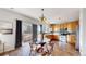 Bright eat-in kitchen features a glass table, stainless steel appliances and wood cabinets at 6898 W Rockland Pl, Littleton, CO 80128