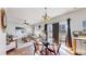 Open-concept living room with dining area, hardwood floors, and modern decor at 6898 W Rockland Pl, Littleton, CO 80128