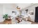 Bright living room featuring modern furnishings, stylish decor, and hardwood floors at 6898 W Rockland Pl, Littleton, CO 80128