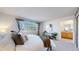 Bright main bedroom features a large window and attached bathroom at 6898 W Rockland Pl, Littleton, CO 80128