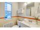Well-lit bathroom featuring a vanity, toilet, and tiled walls at 1100 Colorado Blvd # 305, Denver, CO 80206