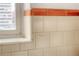 Close up of the bathroom with orange tile, window and white painted walls at 1100 Colorado Blvd # 305, Denver, CO 80206