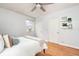Bright bedroom with hardwood floors, a ceiling fan, and two closets at 1100 Colorado Blvd # 305, Denver, CO 80206