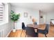 Bright dining area featuring a round table, four chairs, and hardwood floors at 1100 Colorado Blvd # 305, Denver, CO 80206