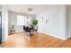 Dining area offers natural light with a modern table, chairs, and beautiful hardwood floors at 1100 Colorado Blvd # 305, Denver, CO 80206