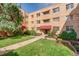 Well-maintained building with beautiful landscaping, mature trees, and brick exterior at 1100 Colorado Blvd # 305, Denver, CO 80206