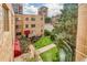 The complex is a multi-story brick building with well-maintained green spaces at 1100 Colorado Blvd # 305, Denver, CO 80206