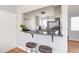 Updated kitchen with granite countertops, breakfast bar, and stainless steel appliances at 1100 Colorado Blvd # 305, Denver, CO 80206
