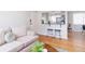 Cozy living room with hardwood floors, a comfortable sofa, and a breakfast bar with seating at 1100 Colorado Blvd # 305, Denver, CO 80206