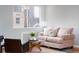 Cozy living room featuring a comfortable pink sofa, stylish decor, and a large window offering natural light at 1100 Colorado Blvd # 305, Denver, CO 80206