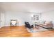 Open-concept living room with hardwood floors and neutral paint at 1100 Colorado Blvd # 305, Denver, CO 80206