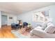 Bright living room with hardwood floors, comfortable seating, and a colorful area rug at 1100 Colorado Blvd # 305, Denver, CO 80206