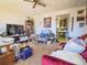 Inviting living room featuring cozy seating, ample natural light, and a ceiling fan for comfortable living at 871 S Worchester St, Aurora, CO 80012