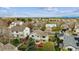 An aerial view of homes featuring green trees and spacious lawns on a sunny day at 5174 S Ukraine St, Aurora, CO 80015