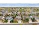 A birds eye view of suburban homes with green trees and yards on a sunny day at 5174 S Ukraine St, Aurora, CO 80015