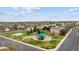 Aerial view of a community park featuring a playground, basketball court and green spaces at 5174 S Ukraine St, Aurora, CO 80015