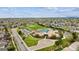 Aerial view of a community school with an adjacent park, baseball field, and neighborhood homes at 5174 S Ukraine St, Aurora, CO 80015