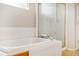 Bathroom featuring a soaking tub with tiled surround and a glass-enclosed shower at 5174 S Ukraine St, Aurora, CO 80015