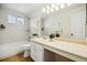 Bright bathroom featuring a tub-shower combo, vanity, and large mirror at 5174 S Ukraine St, Aurora, CO 80015
