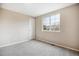 Bright, neutrally painted bedroom with carpet and a double-hung window at 5174 S Ukraine St, Aurora, CO 80015