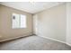 Neutrally painted bedroom with carpet, white trim, and a double-hung window at 5174 S Ukraine St, Aurora, CO 80015
