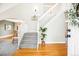 Bright foyer with hardwood floors, staircase, and views into the dining and living spaces at 5174 S Ukraine St, Aurora, CO 80015