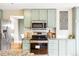 Updated kitchen features stainless steel appliances, granite countertops, and a view into the eat in kitchen area at 5174 S Ukraine St, Aurora, CO 80015