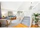 Open-concept living room with wood floors, carpet, staircase, and natural light at 5174 S Ukraine St, Aurora, CO 80015