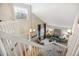 Bright living room, as seen from the stairway, with vaulted ceilings and contemporary furnishings at 5174 S Ukraine St, Aurora, CO 80015