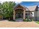 Stone and stucco home with a large covered porch at 4479 Tierra Alta Dr, Castle Rock, CO 80104