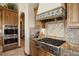 Luxury kitchen features Wolf range and custom cabinetry at 4479 Tierra Alta Dr, Castle Rock, CO 80104