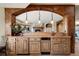 Basement wet bar with custom cabinetry and lighting at 4479 Tierra Alta Dr, Castle Rock, CO 80104