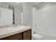 Bathroom with a tiled shower over tub, vanity, toilet and mirror at 1775 Aspen Meadows Cir, Denver, CO 80260