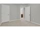 Neutral bedroom with a plush carpet, features two doors and easy access to the bathroom at 1775 Aspen Meadows Cir, Denver, CO 80260