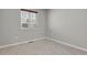 Carpeted bedroom with a window and neutral gray walls at 1775 Aspen Meadows Cir, Denver, CO 80260
