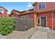 Detailed view of the red townhome's entry, showcasing landscaping and modern door at 1775 Aspen Meadows Cir, Denver, CO 80260