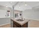 Kitchen island with granite countertop, stainless steel dishwasher, and hardwood-style flooring at 1775 Aspen Meadows Cir, Denver, CO 80260