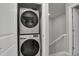 Convenient, space-saving, stacked washer and dryer units located near the staircase at 1775 Aspen Meadows Cir, Denver, CO 80260