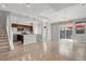 Spacious living area flowing into a modern kitchen with hardwood floors and sliding glass door at 1775 Aspen Meadows Cir, Denver, CO 80260