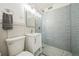 Modern bathroom featuring a glass door shower, clean white sink and toilet, and gray accent tiling at 2100 N Franklin St # 8, Denver, CO 80205