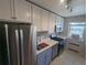 Bright kitchen with stainless steel appliances, white cabinets, and tile flooring provides the ideal space for cooking and dining at 2100 N Franklin St # 8, Denver, CO 80205