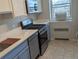 This kitchen boasts stainless steel appliances, tile flooring, and plenty of natural light from the large window at 2100 N Franklin St # 8, Denver, CO 80205