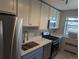 Modern kitchen featuring stainless steel appliances, white cabinets, and a kitchen sink with a custom cutting board at 2100 N Franklin St # 8, Denver, CO 80205